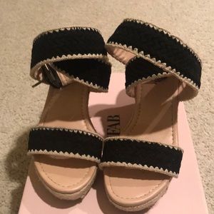 Black and cream colored wedge sandals